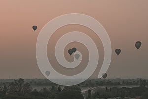 View of a scenic sunrise with many hot air balloons above Bagan in Myanmar. Bagan is an ancient city with thousands of historic