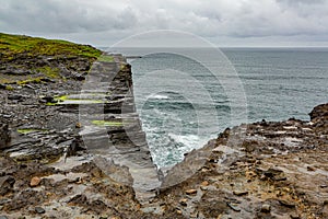 View of the sea and cliffs of limestone rocks along the coastal walk route from Doolin to the Cliffs of Moher