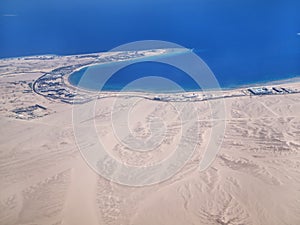 View on the sea and the desert from an airplane