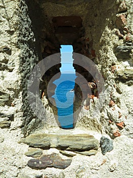 A view of the sea through the loophole of a medieval fort in the southern part of Colliure, France photo