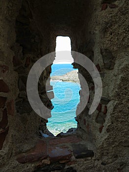 A view of the sea through the loophole of a medieval fort in the southern part of Colliure, France