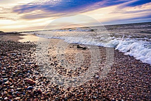 View of the sea over a stony beach