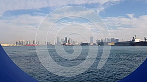 View of the sea port and blue ocean on a sunny day. View of the blue ocean through the porthole of a cruise liner.