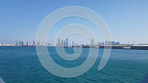 View of the sea port and blue ocean on a sunny day. View of the blue ocean through the porthole of a cruise liner.