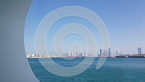 View of the sea port and blue ocean on a sunny day. View of the blue ocean through the porthole of a cruise liner.