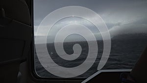 View of the sea from the porthole of the ship. dark mood