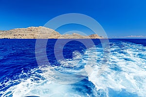 View from the sea on the rocks, and trace of the boat. Greece Rhodes Island