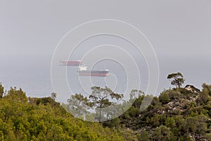 View of the sea, ships in the distance and mountains