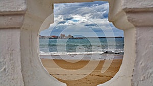 A view of the sea shore sky storm from the beach through the railing