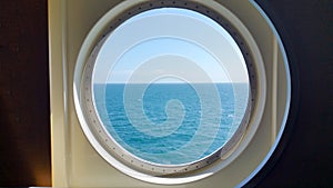 View of the sea surface through a porthole of the ship
