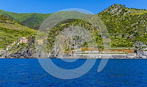 A view from the sea towards the railway station for the Cinque Terre village of Manarola, Italy