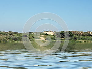 View from the sea of a winding path through sand dunes and grass on the merseyside coast near formby