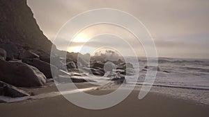 View of a seascape with waves hitting the rocks during the sunset