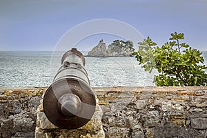 View seaward following the line of a cannon on the ramparts of the old Venetian fortress in Petrovac, Montenegro