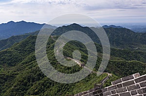 View of a section of the Great Wall of China and the surrounding mountains in Mutianyu