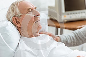 View of senior woman and ill senior man in hospital