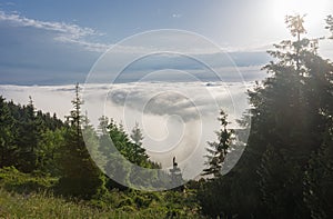 View from  Serak in Jeseniky mountains on a summer foggy morning and  sea of clouds around mountain peak