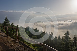 View from  Serak in Jeseniky mountains on a summer foggy morning and  sea of clouds around mountain peak