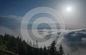 View from  Serak in Jeseniky mountains on a summer foggy morning and  sea of clouds around mountain peak