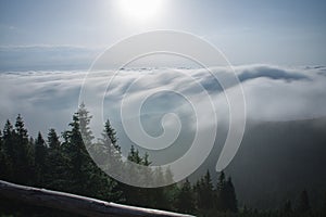 View from  Serak in Jeseniky mountains on a summer foggy morning and  sea of clouds around mountain peak