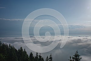 View from  Serak in Jeseniky mountains on a summer foggy morning and  sea of clouds around mountain peak