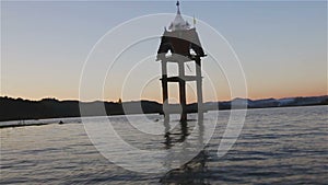 View of service boat floating passed underwater city, Wat Wang Wiwekaram Kao, in evening, Sangkhlaburi District, Kanchanaburi Thai