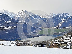 View of the settlement of Amden above the Lake Walen or Lake Walenstadt Walensee and the fertile lowlands - Switzerland