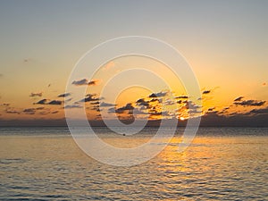 A view of Seven Mile Beach in Grand Cayman Island with a beautiful sunset