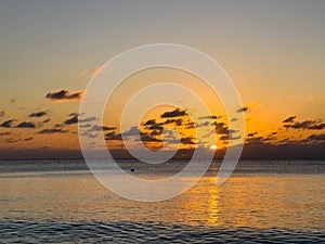 A view of Seven Mile Beach in Grand Cayman Island with a beautiful sunset