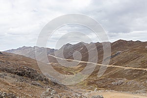 View of several hills high in the Peruvian highlands of various vegetation and colors in the morning, located in Shupluy