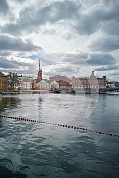 View of several historic building behind river in old Stockholm town. Place of oldest Swedish book publishing company - Norstedts photo