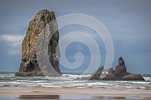 View of several large sea stacks in the ocean at Cannon Beach, Oregon.