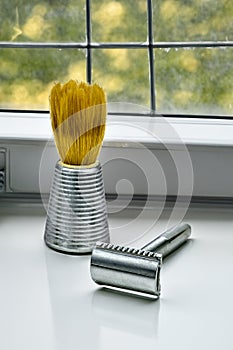 View of a shaving brush and razors