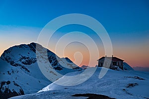 View of a shelter in the snow covered Vardousia mountains in Greece at sunset