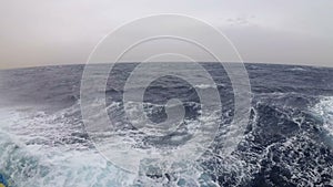 View from a ship moving along the waves in a strong storm in the Red Sea