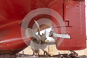 View on the ships rudder and propeller. Ship in a dry dock.