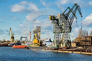 View of the shipyard with historical cranes in the industrial part of the city Gdansk in Poland Polska. The shipyard is