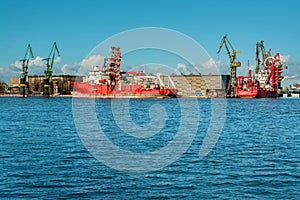 View of the shipyard with historical cranes in the industrial part of the city Gdansk in Poland. The shipyard is