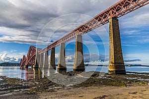 A view from the shoreline in Queensferry of the Forth Railway bridge over the Firth of Forth, Scotland