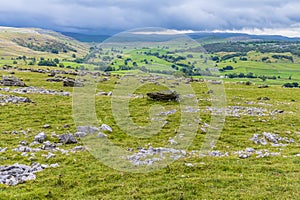 A view showing glacial erratics deposited on the limestone pavement on the southern slopes of Ingleborough, Yorkshire, UK photo