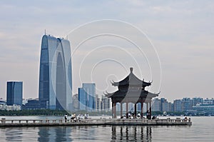 View on Shuzhou business centre with pagoda and lake in foreground