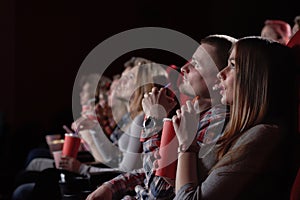 Group watching intriguing movie in cinema.