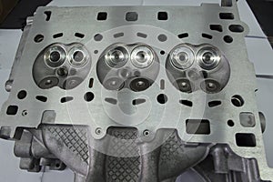 View from the side of the valves on the head of the three-cylinder engine block