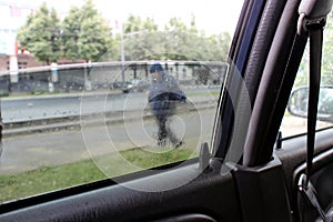 View from the side window of the car to the street through the deflated half glass
