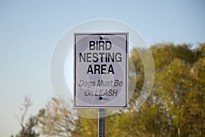 View of sign Bird Nesting Area, Dogs Must be on Leash in Courtenay photo