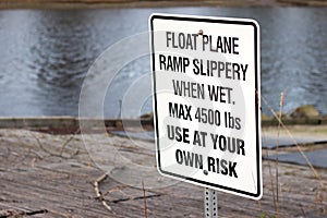 View of sign Float Plane Ramp Slippery When Wet, Use At Your Own Risk in Courtenay photo