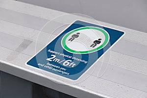 View of sign `Support physical distancing 2 metres between you and other passengers`