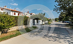 View on silent street with country two-storey houses with gates