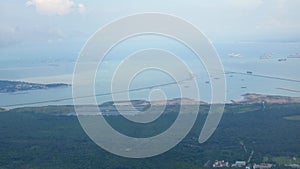 view of singapore bay coast harbor from above sky from airplane while take off from singapore airport. Daytime aerial view of