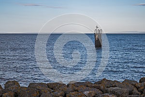 A view of a single guide post, in the Bristol channel, just outside of Cardiff Bay.